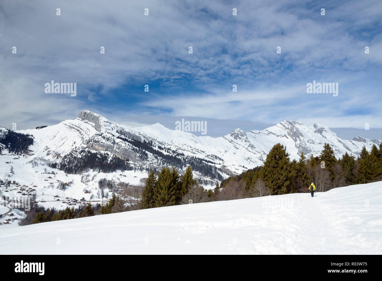 Woman snowshoeing in Le Grand-Bornand, Haute-Savoie, France, Stock Photo