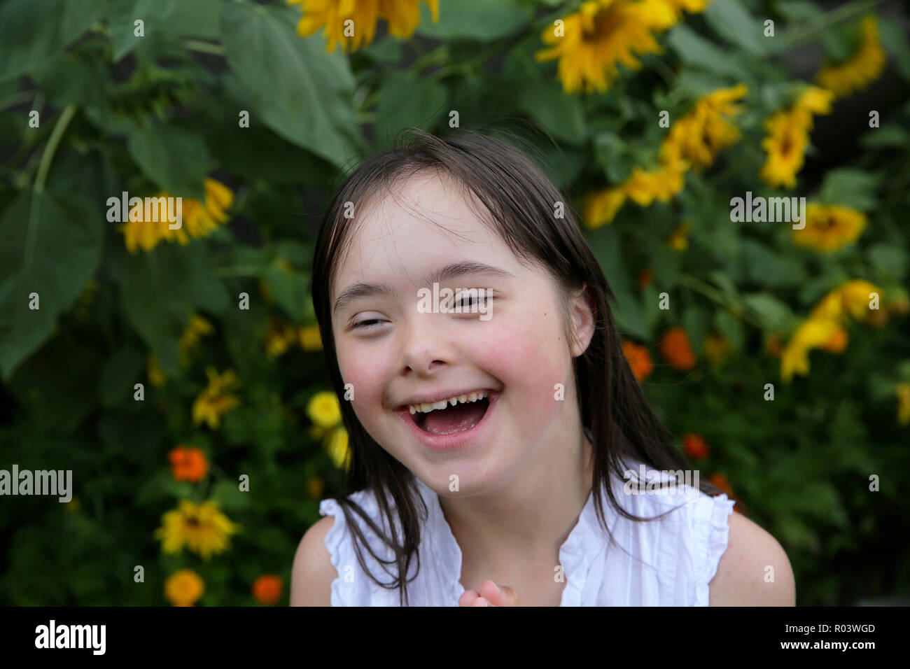 Portrait of little girl smiling in the garden Stock Photo - Alamy