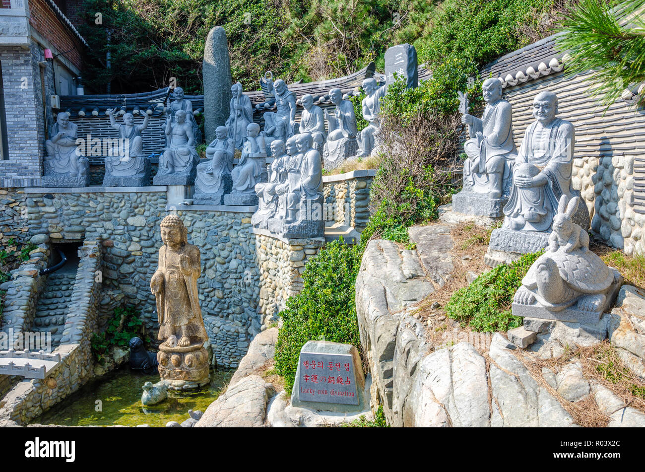 Stone figures at the 'Lucky Coin Divination' at Haedong Yonggungsa Temple in Busan, South Korea Stock Photo