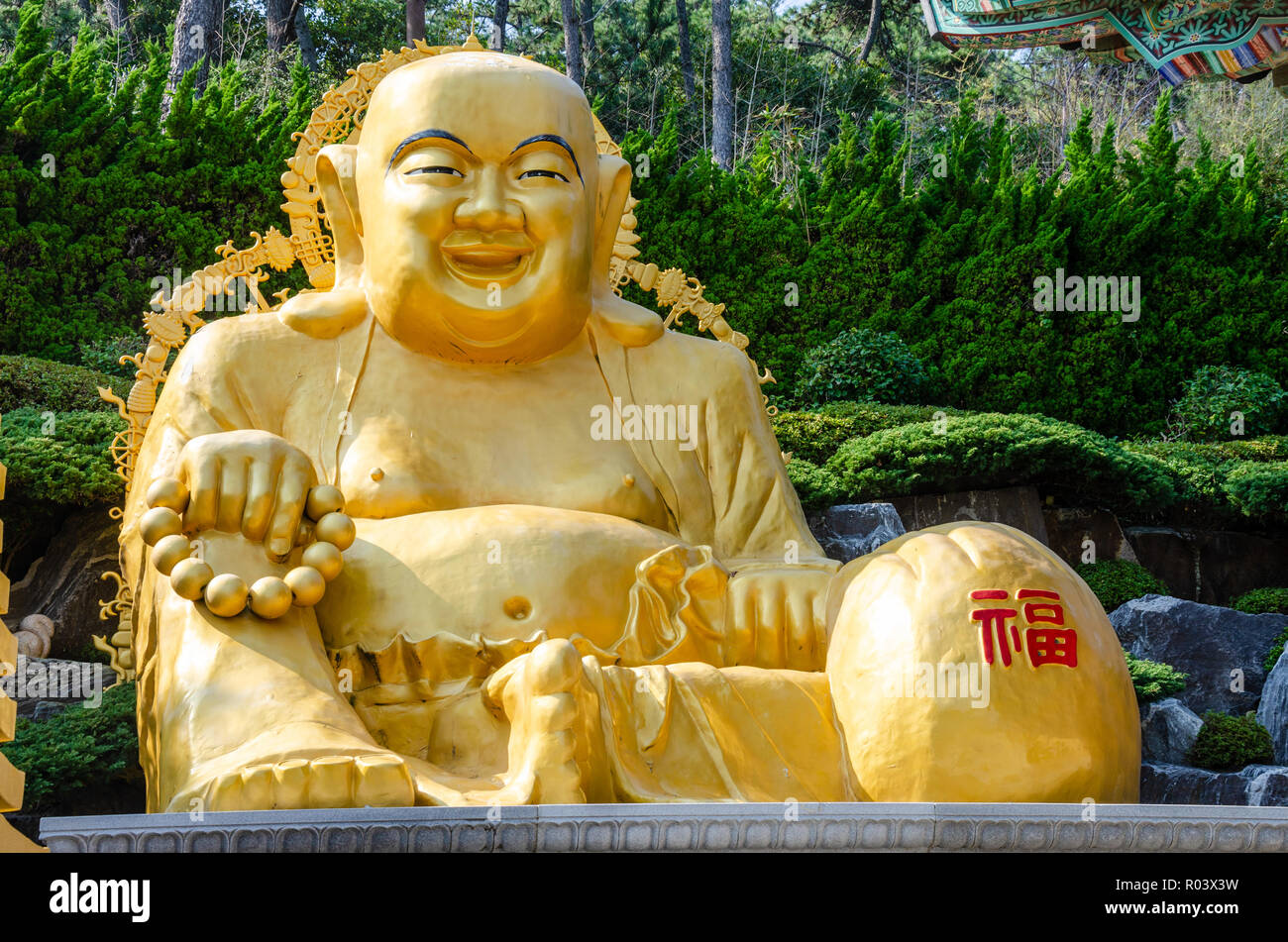 A golden Buddha at Haedong Yonggungsa Temple, a Buddhist temple in Busan, South Korea. Stock Photo