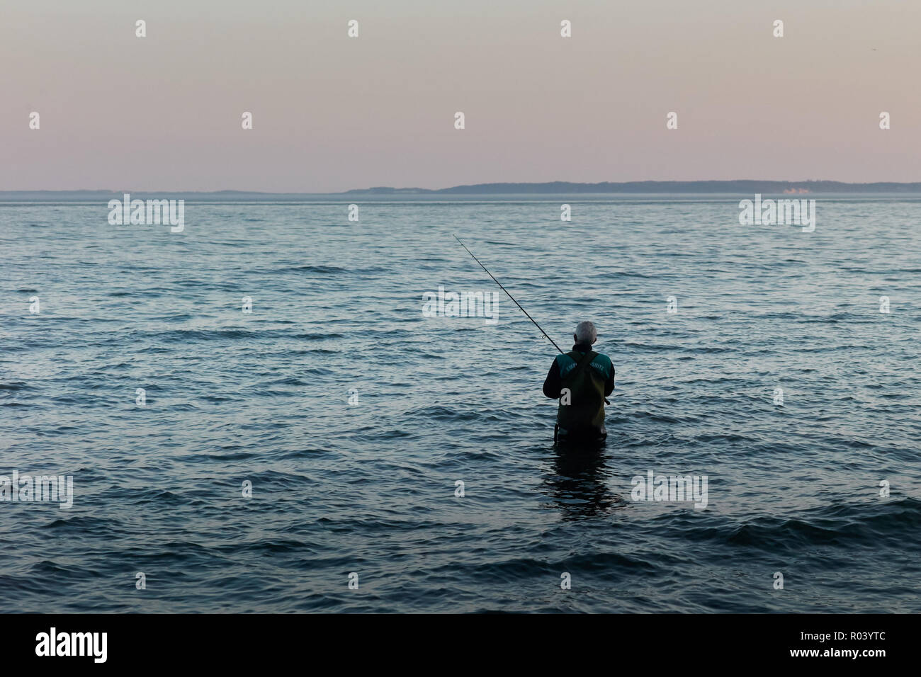 Baltic island Ruegen, Mecklenburg-Western Pomerania, Germany - Angler fishing in the water Stock Photo
