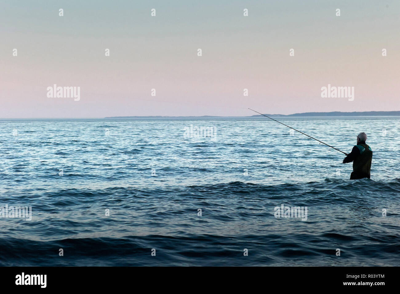 Baltic island Ruegen, Mecklenburg-Western Pomerania, Germany - Angler fishing in the water Stock Photo