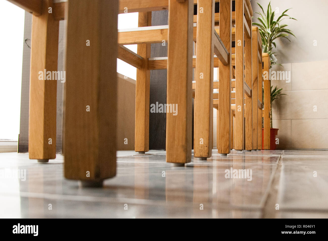 A row of wooden bar stools in a bistro Stock Photo