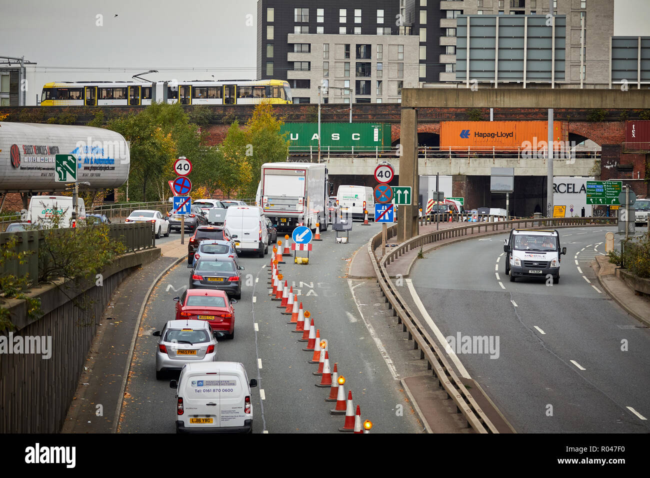 Roadworks creating busy traffic queue jams in one direction  on A57 M  The Mancunian Way  two mile long elevated motorway  Manchester city centre Stock Photo