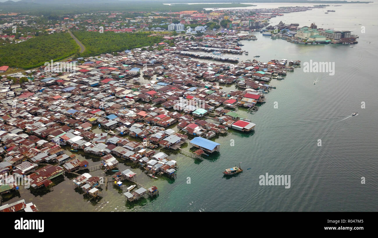 Partial view of Semporna town located at east coast of Sabah Malaysia Borneo with large area water village houses call Kampung Simunul at foreground. Stock Photo