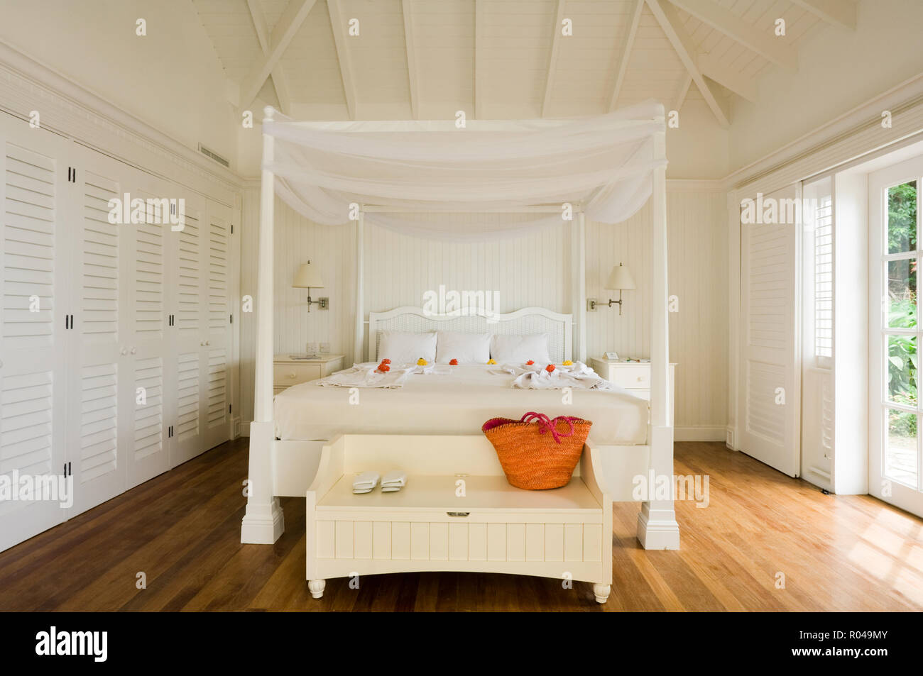 Bedroom with white four poster bed Stock Photo Alamy