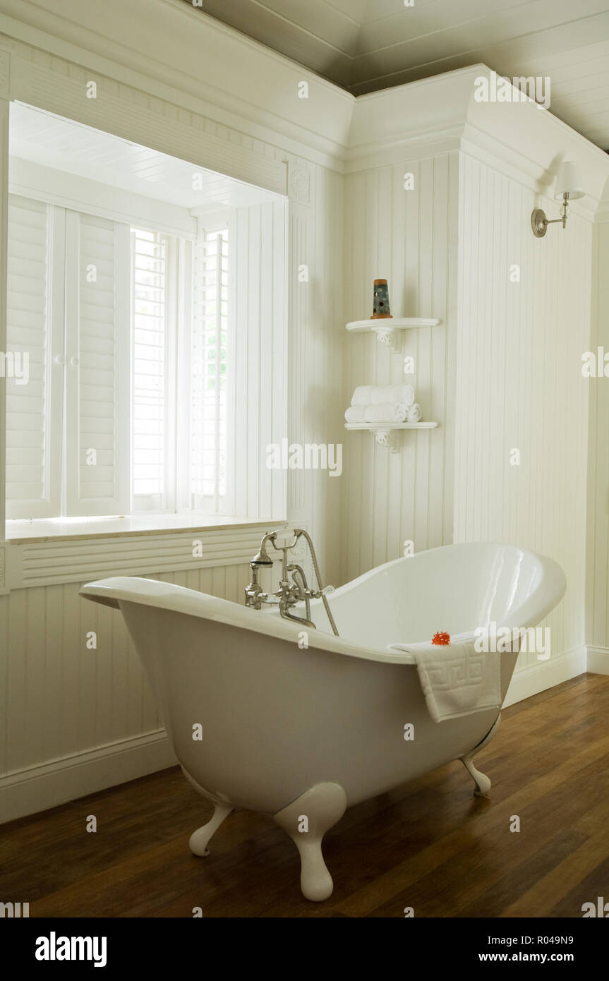 Freestanding bathtub by window Stock Photo