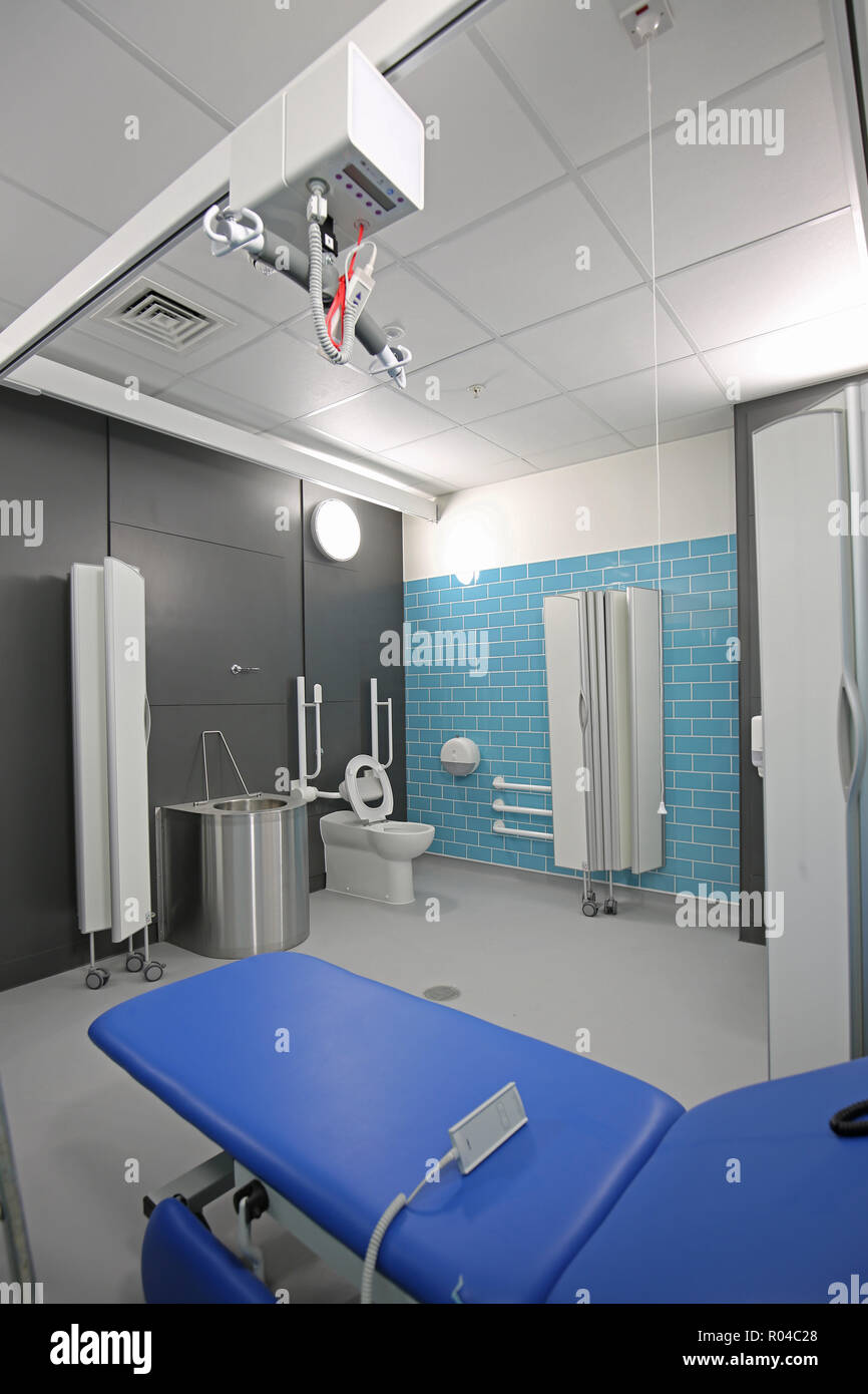 Toilet and hygene room in a new special school for children with severe learning difficulties, Southwark, London, UK. Shows bed with disabled hoist. Stock Photo