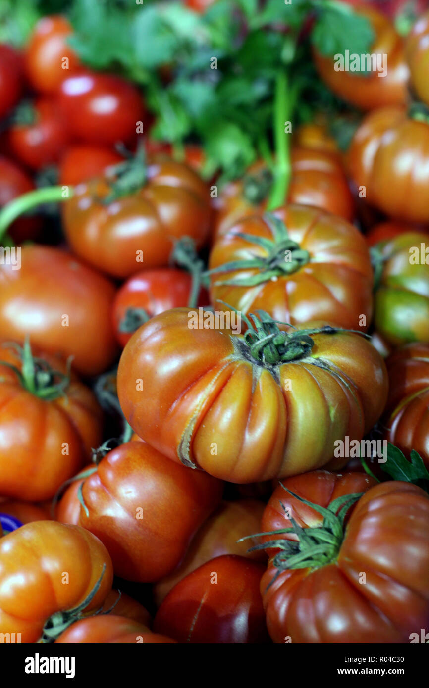 Close up of large vibrant orange beefsteak tomatoes Stock Photo