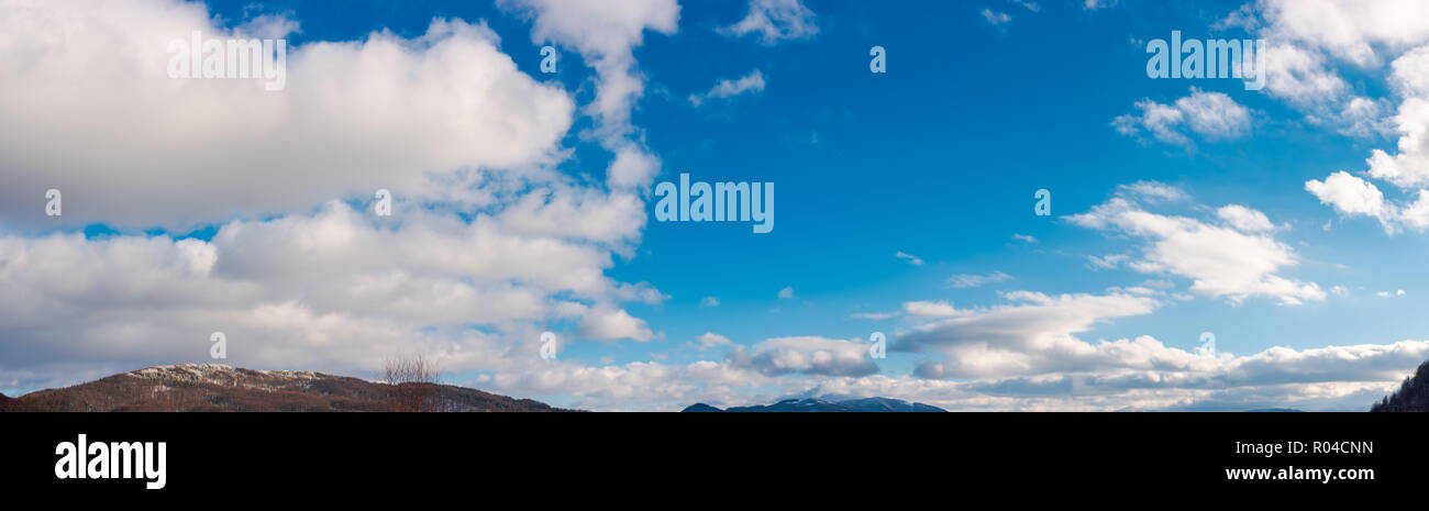 panorama of wonderful winter sky with fluffy clouds above the ridge. beautiful nature background, useful for compositing Stock Photo