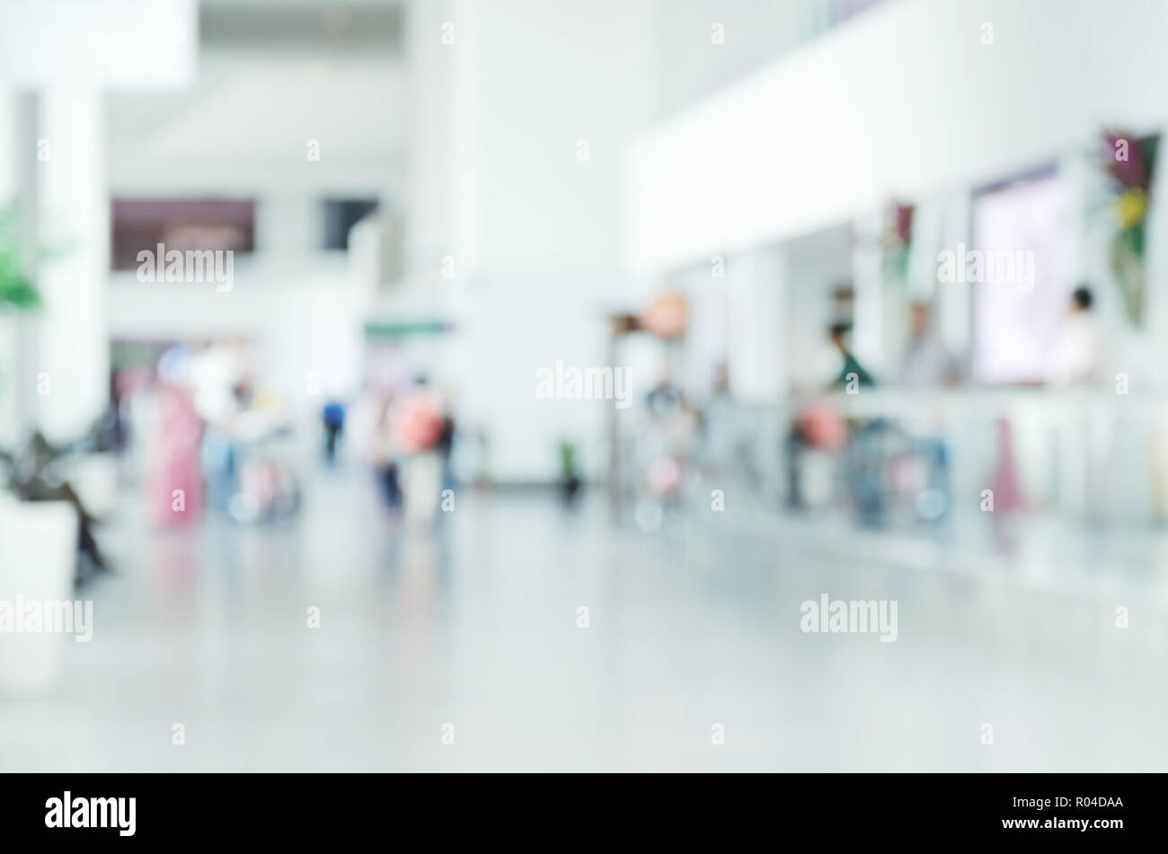 Blurred photo with people at airport, defocused silhouettes indoors, unrecognizable persons, abstract background, empty place for text,  copy space Stock Photo