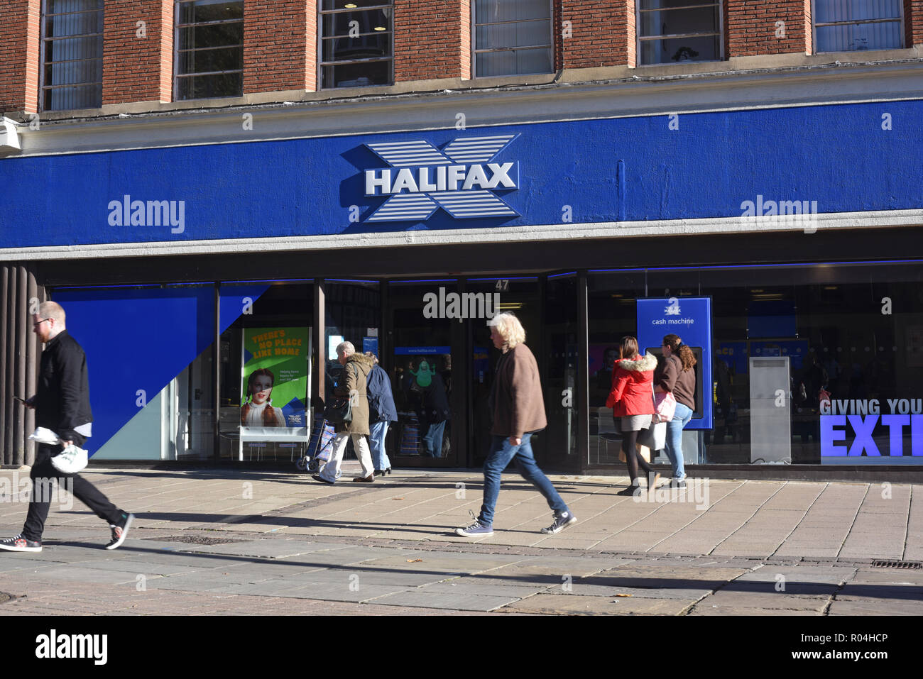 shoppers passing halifax bank branch in york yorkshire united kingdom