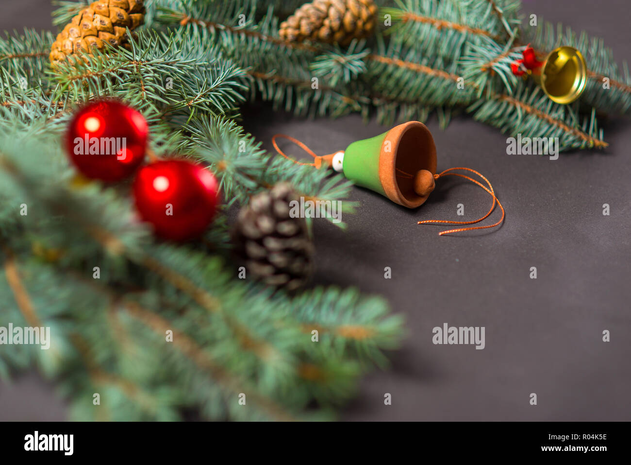 Winter fir and christmas tree with ceramic bell and red globes Stock Photo