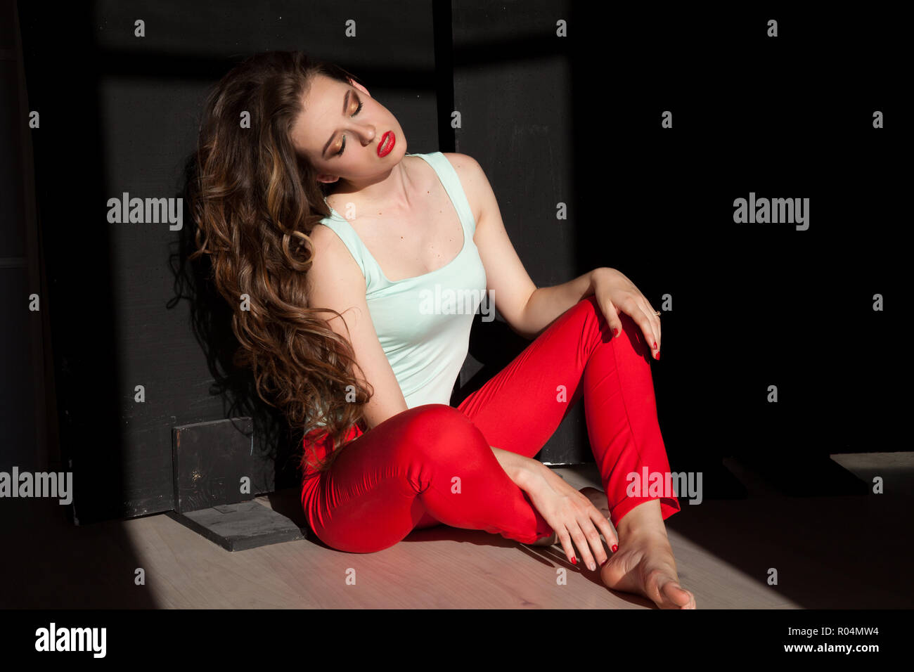 Portrait of a beautiful girl with long hair sitting Stock Photo - Alamy