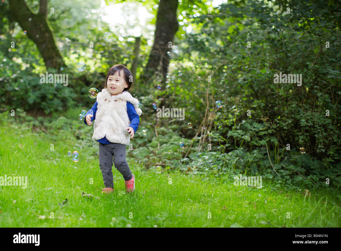 baby girl play bubble at Spring garden Stock Photo - Alamy