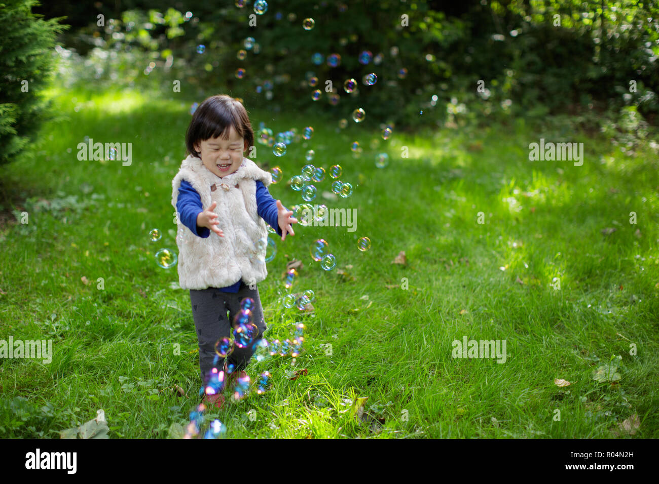 baby girl play bubble at Spring garden Stock Photo - Alamy