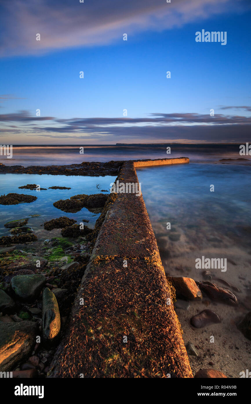 By the coast of scottish Highlands - sunset time on the beach. View on the Northern Sea. Stock Photo