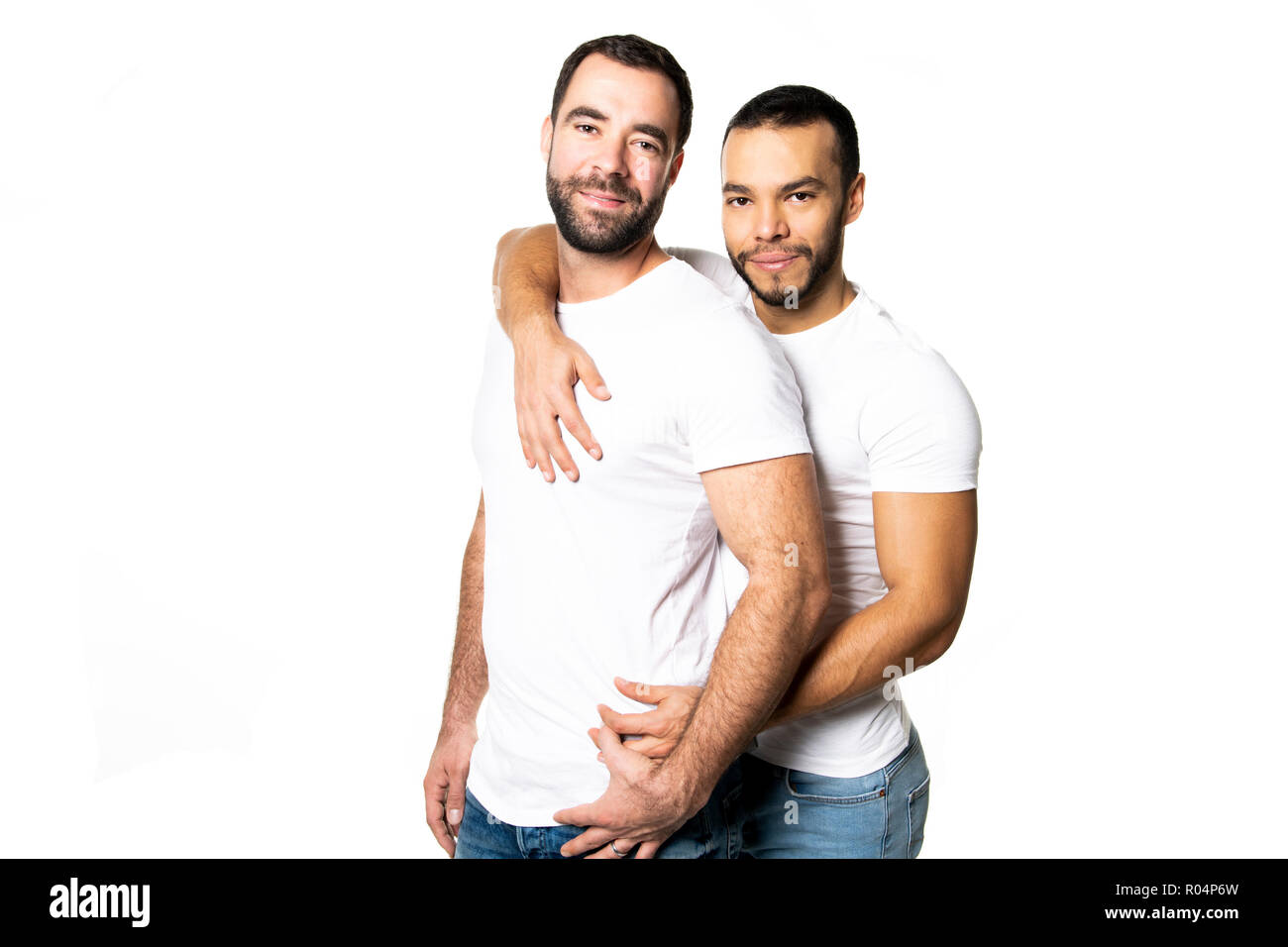 Young homosexuals gay couple love each other on a white background. Stock Photo