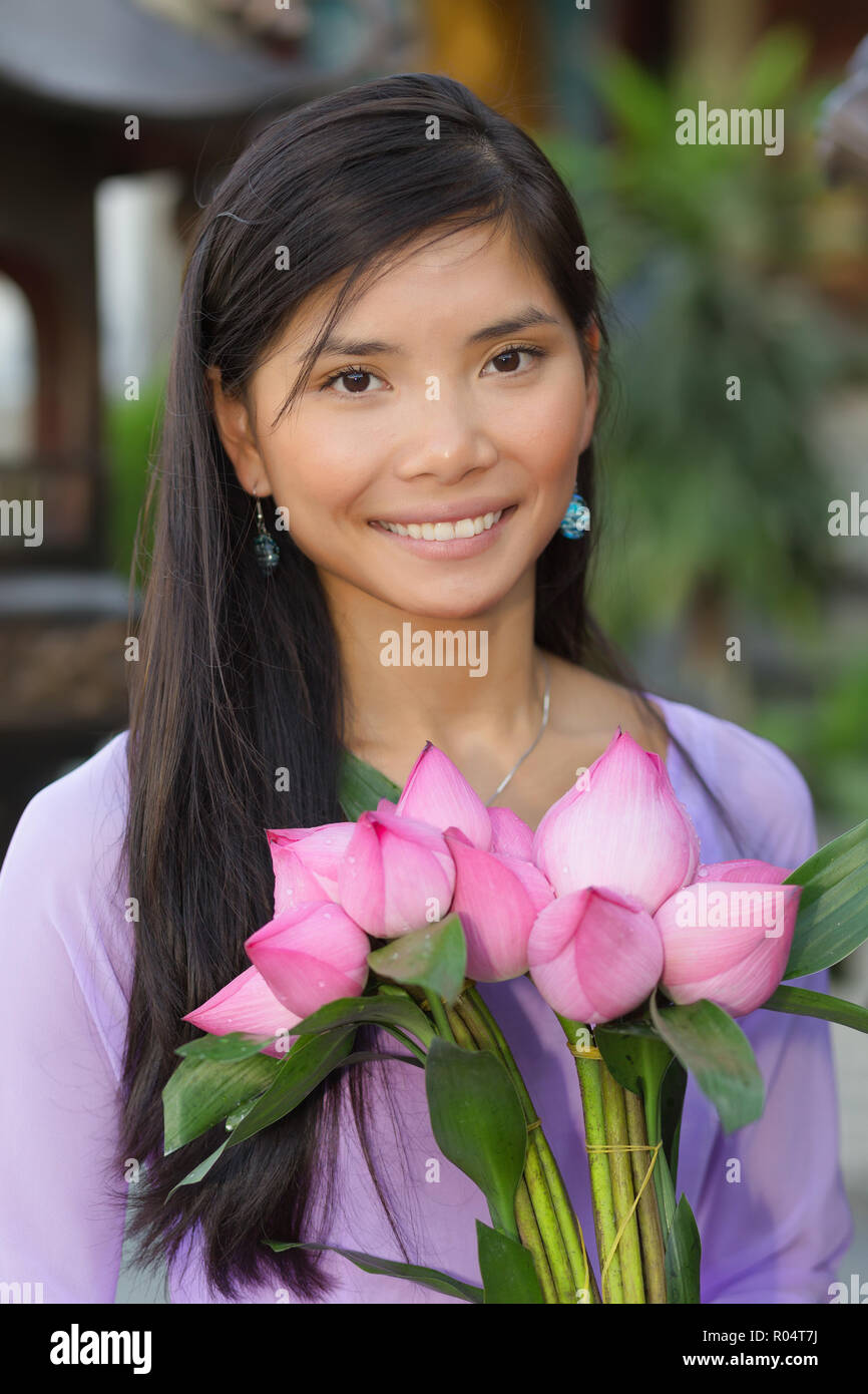 Pretty Asian woman holding lotus flowers bunch Stock Photo Alamy