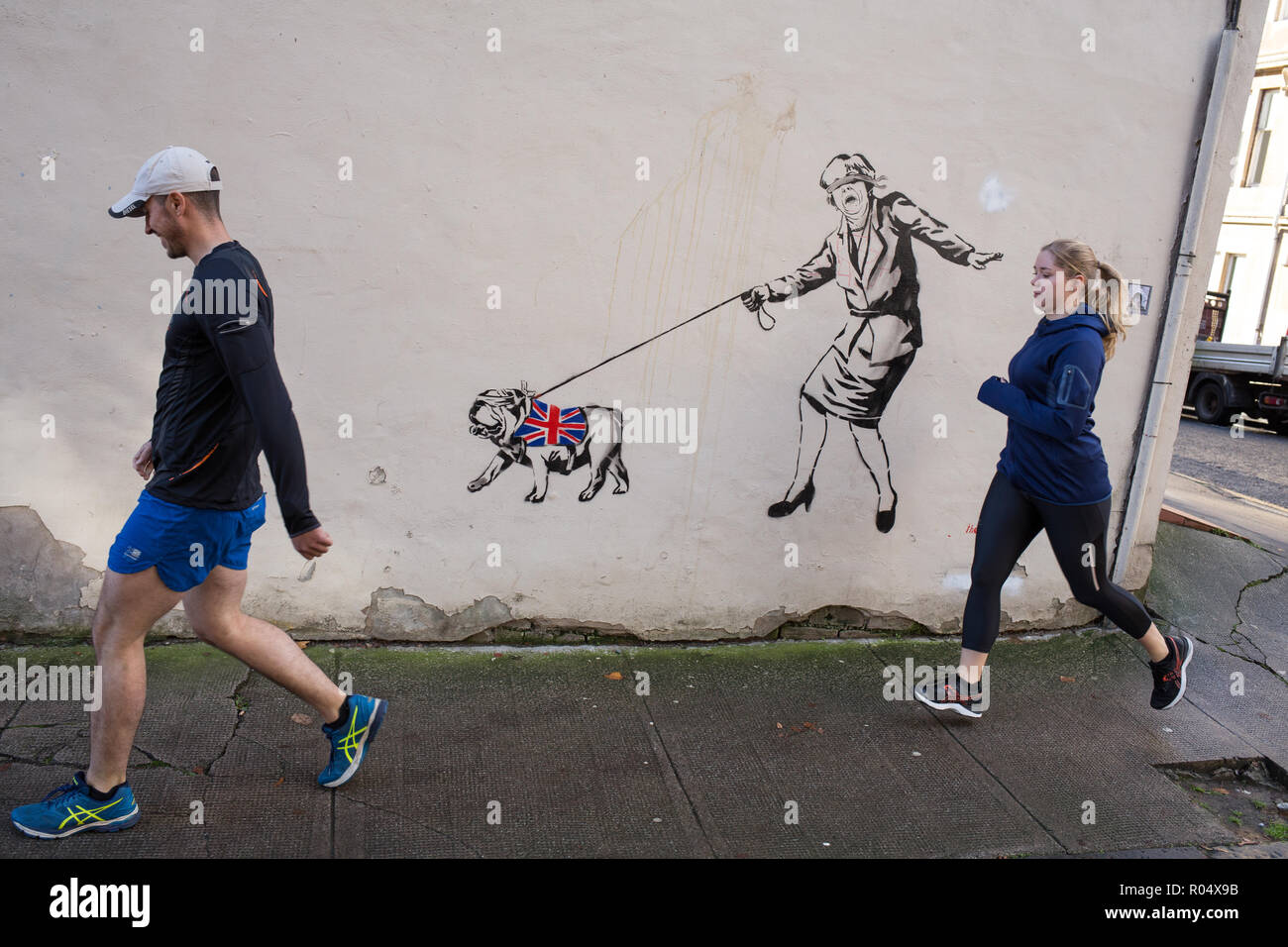 Glasgow, Scotland, 1st November 2018. A blindfolded Prime Minister Theresa May leading a British bulldog wearing a Union jack coat - a Brexit commentary street art stencilled graffiti /mural by the artist known as 'The Pink Bear Rebel', in the West End of Glasgow, Scotland, on 01 November 2018. Image Credit: Jeremy Sutton-Hibbert/Alamy News Credit: jeremy sutton-hibbert/Alamy Live News Stock Photo