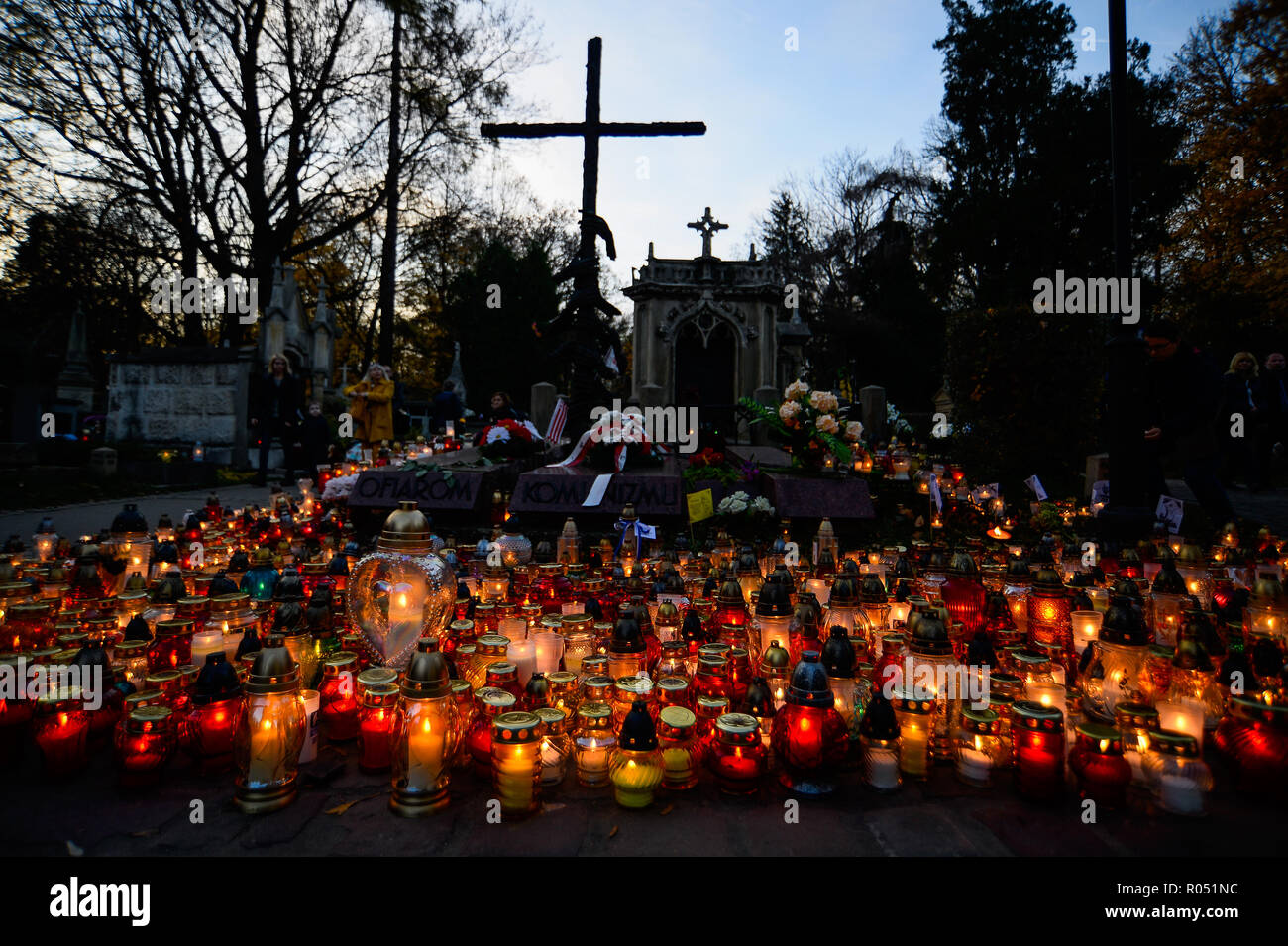 Krakow, Poland. 1st Nov, 2018. Lamps are seen lighting next to a monument at the Rakowicki Cemetery during the celebrations.All Saints Day, also known as The Day of the Dead, is a Roman Catholic day of remembrance of friends and loved ones who have passed away. Credit: Omar Marques/SOPA Images/ZUMA Wire/Alamy Live News Stock Photo