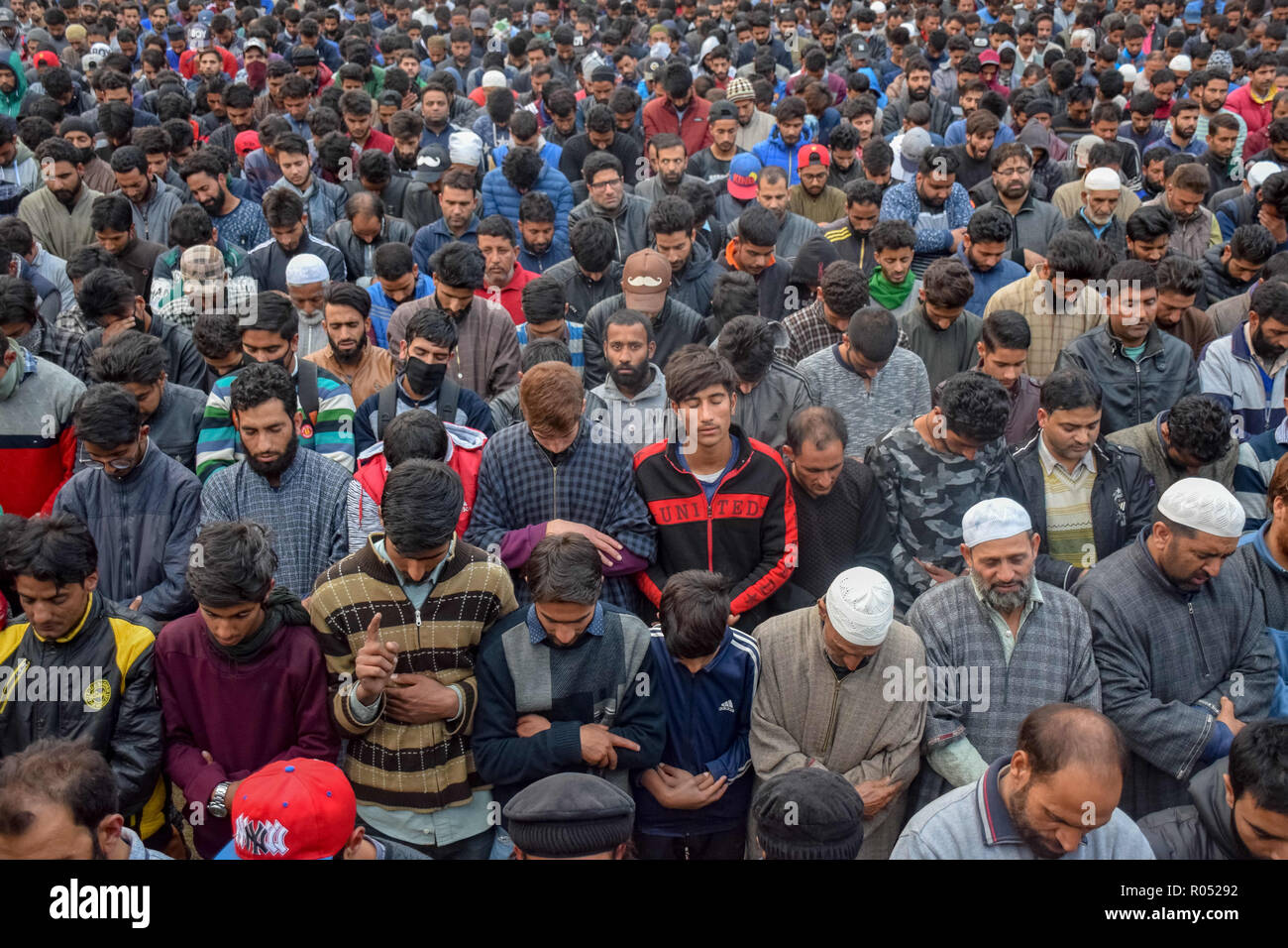 Kashmiri Muslims are seen offering funeral prayers for slain militant Mohd Amin at his residence in Pampore.Thousands of people took part in the funeral prayers of one of the slain militants, Mohd Amin in Pampore area of Pulwama south Kashmir some 20kms from summer capital of Srinagar, Official say two militants were killed in a brief gunfight with Indian forces. Credit: Idrees Abbas/SOPA Images/ZUMA Wire/Alamy Live News Stock Photo