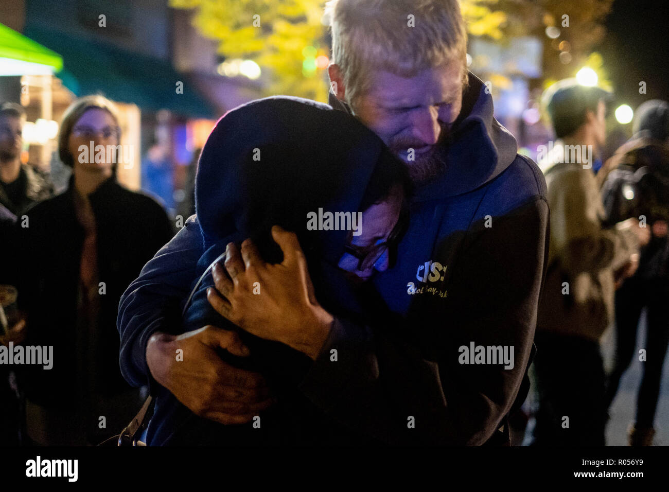 Pittsburgh, PA, USA. 30th Oct, 2018. Couple embraces during the If Not Now When demonstration.In the aftermath of the Tree of Life shootings in Pittsburgh, PA, the If Not Now When protest sits in the middle of the main street in squirrel Hill, police block off roads. Credit: Aaron Jackendoff/SOPA Images/ZUMA Wire/Alamy Live News Stock Photo