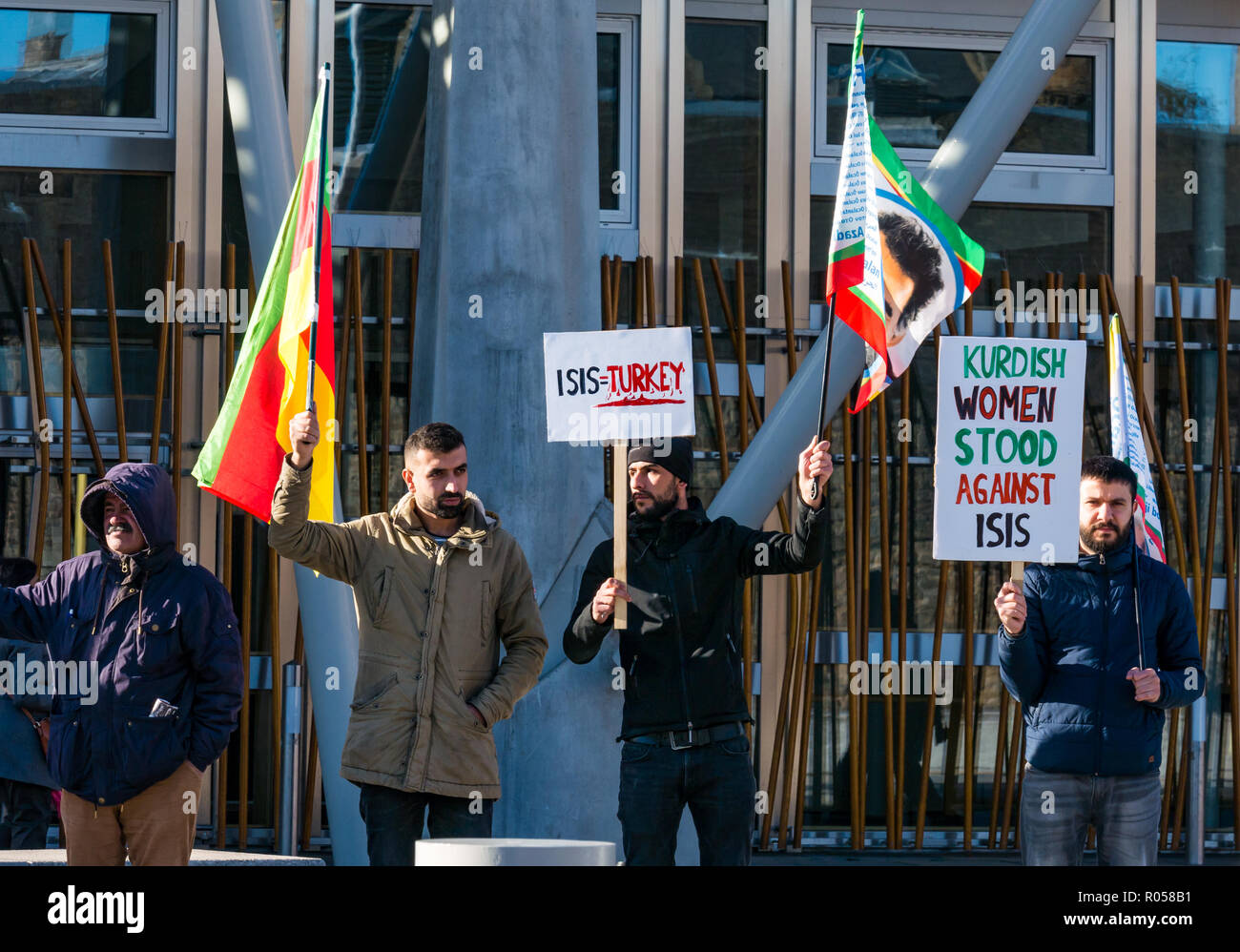 Holyrood, Edinburgh, Scotland, United Kingdom, 2nd November 2018. Kurdish protestors and families stand outside the Scottish Parliament building waving flags supporting the release of Kurdish nationalist Abdullah Öcalan and in protest at the treatment by the Turkish state of Kobane, a city in the Aleppo Governorate in northern Syria Stock Photo