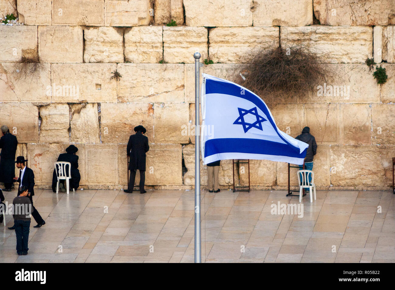 JERUSALEM, ISRAEL - JAN 24, 2011: Jewish worshipers pray at the Western Wailing Wall in Jerusalem, Israel. Stock Photo