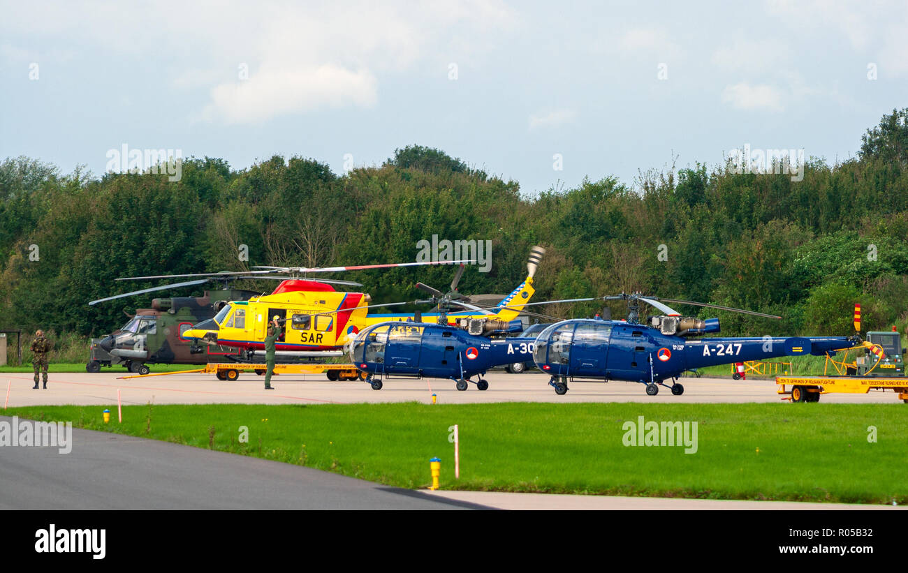 LEEUWARDEN, NETHERLANDS - SEP 17, 2011: Royal Netherlands Air Force Bell 412, Alouette III and Cougar helicopter line-up on Leeuwarden airbase Stock Photo