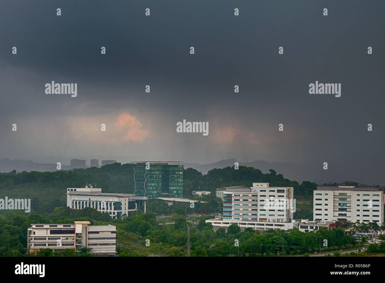 View of approaching rain storm, rainy clouds over the city, poor weather forecast.  Malaysia, Cyberjaya. Tropical cyclone in asia. Stock Photo