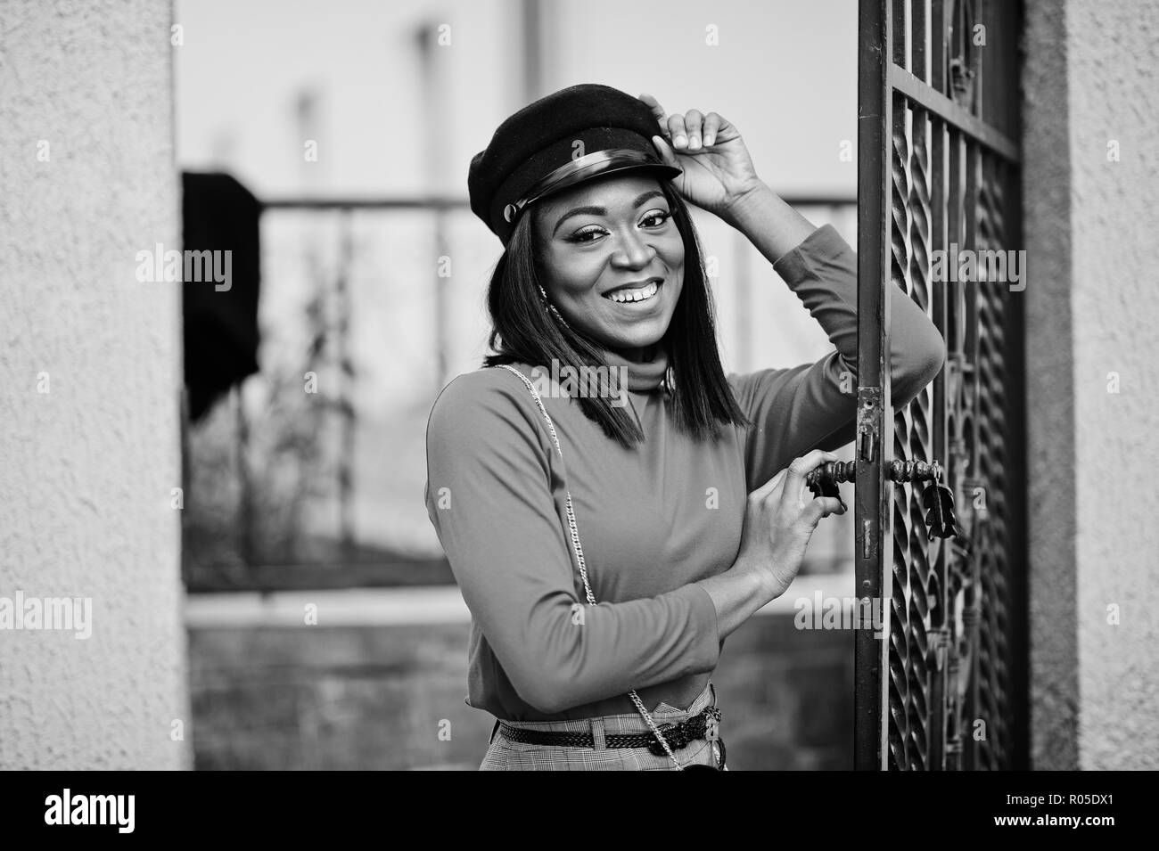 African american fashion girl in newsboy cap posed at street. Stock Photo