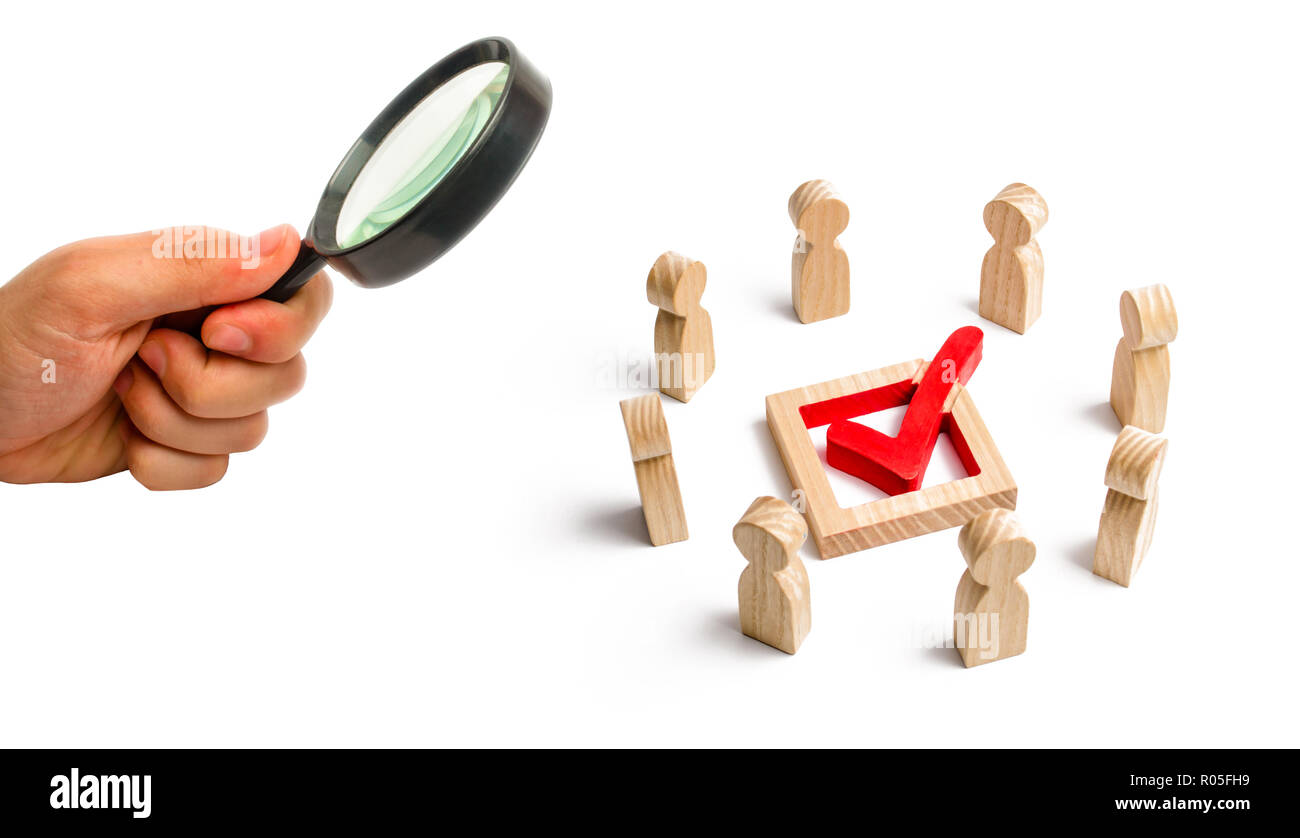 People stand in a circle and look at the check mark in the box