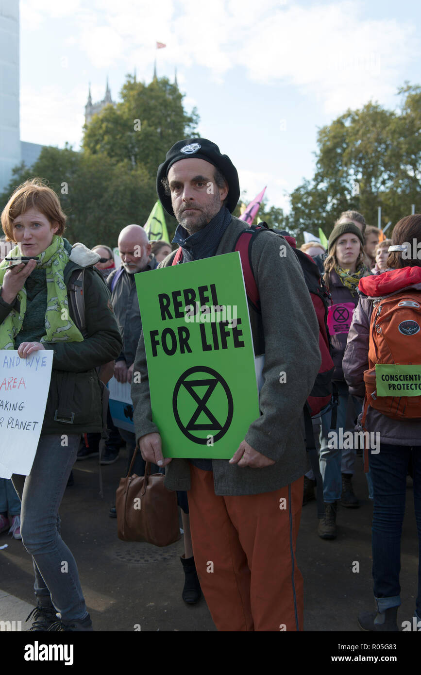 Environmental activist seen holding a placard during the protest. The newly formed Extinction Rebellion group, concerned about climate change, calls for a peaceful mass civil disobedience to highlight politicians’ lack of commitment and action regarding environmental issues. Activists gathered at the Parliament Square and blocked the road for two hour. The protest included speakers such as Greta Thunberg, Caroline Lucas, and George Monbiot. According to Extinction Rebellion 15 people were arrested in the protest. Stock Photo