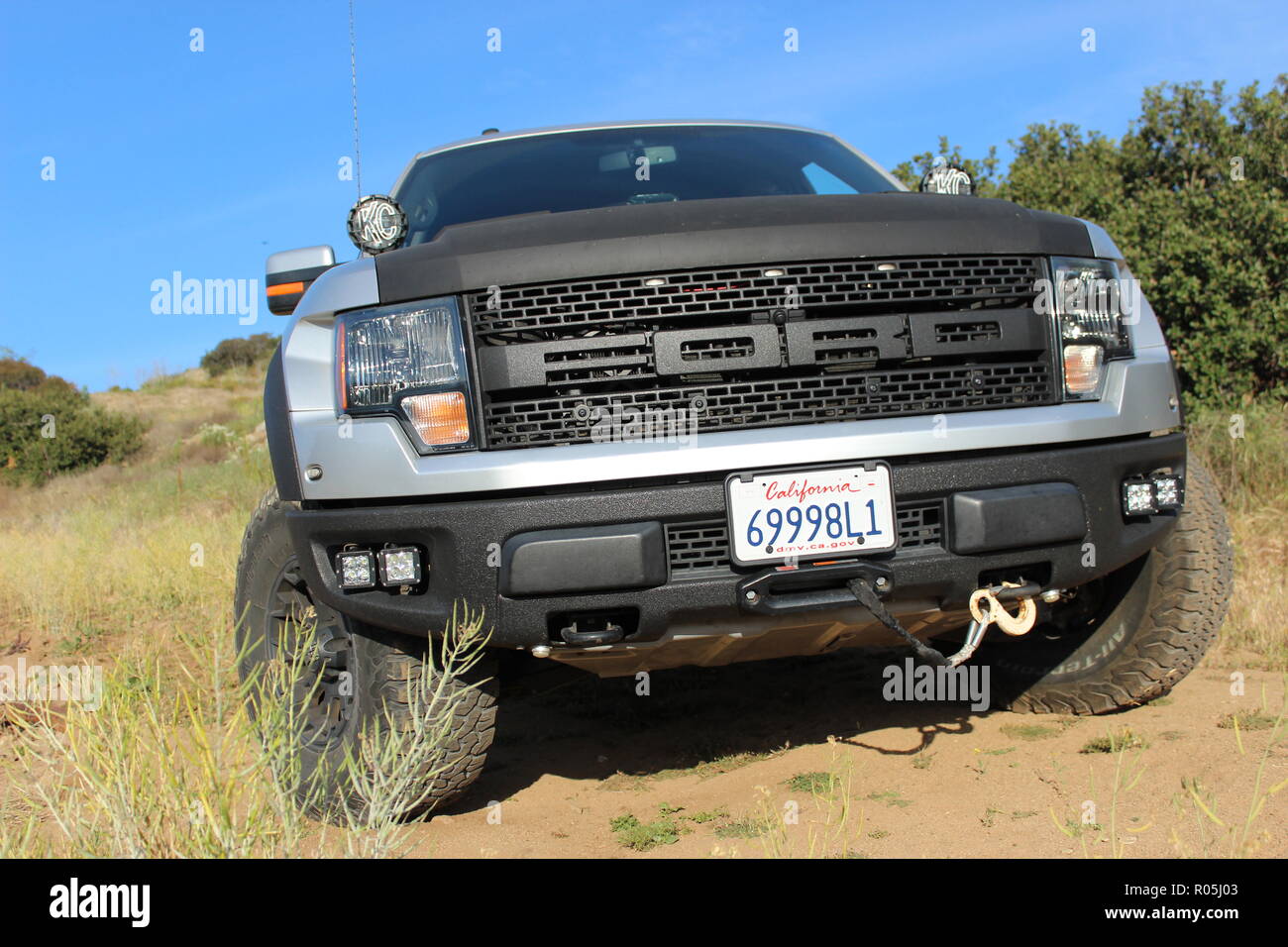 Silver and black customized Ford F150 Raptor SVT on dirt road Stock Photo