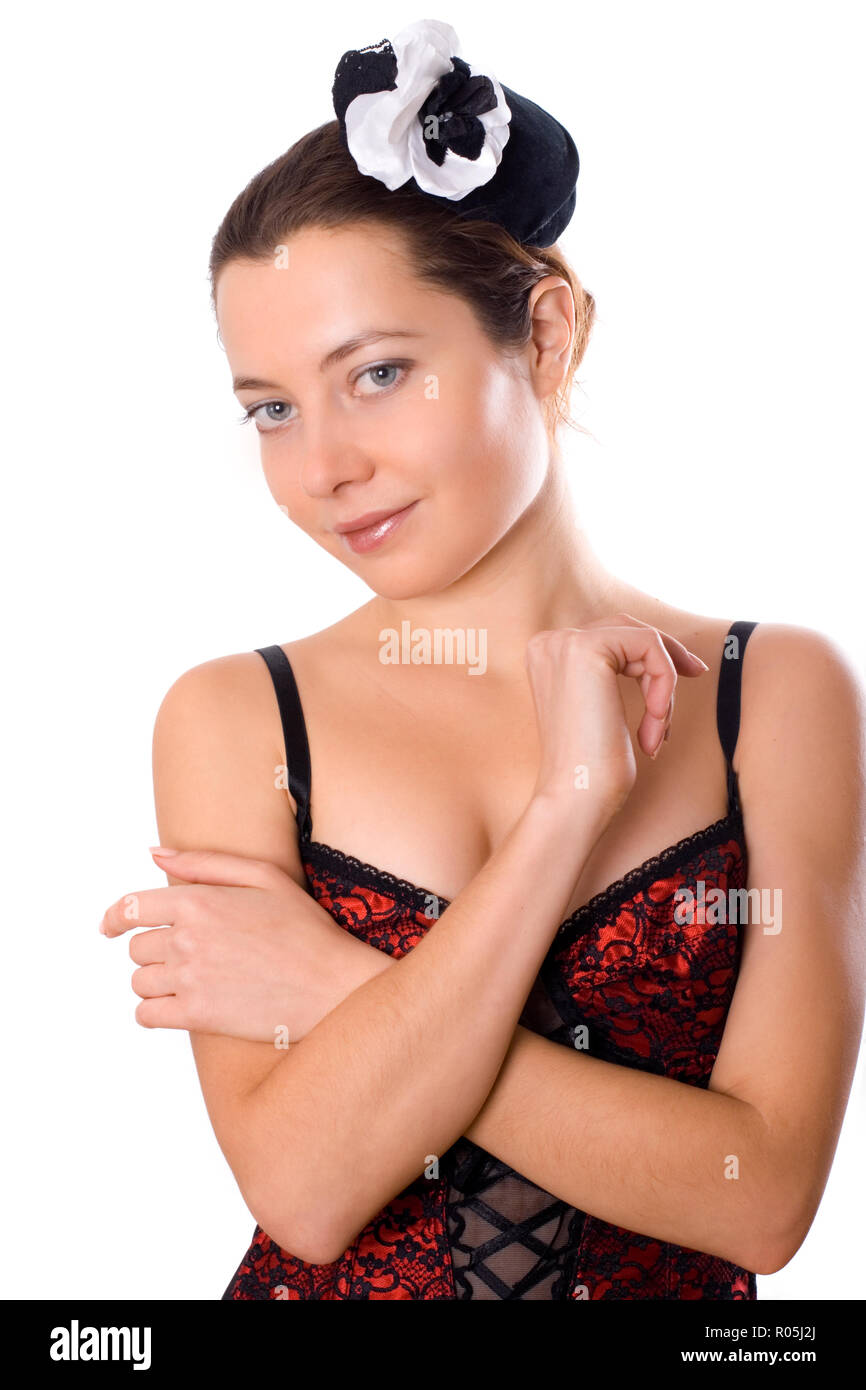 portrait of young attractive woman in corset and little hat on white background Stock Photo