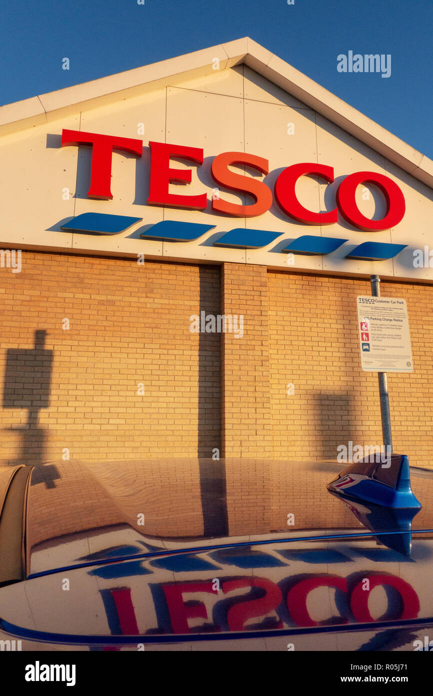 Exterior of Tesco and brand name Sign at sunset in Dinnington, Rotherham Stock Photo