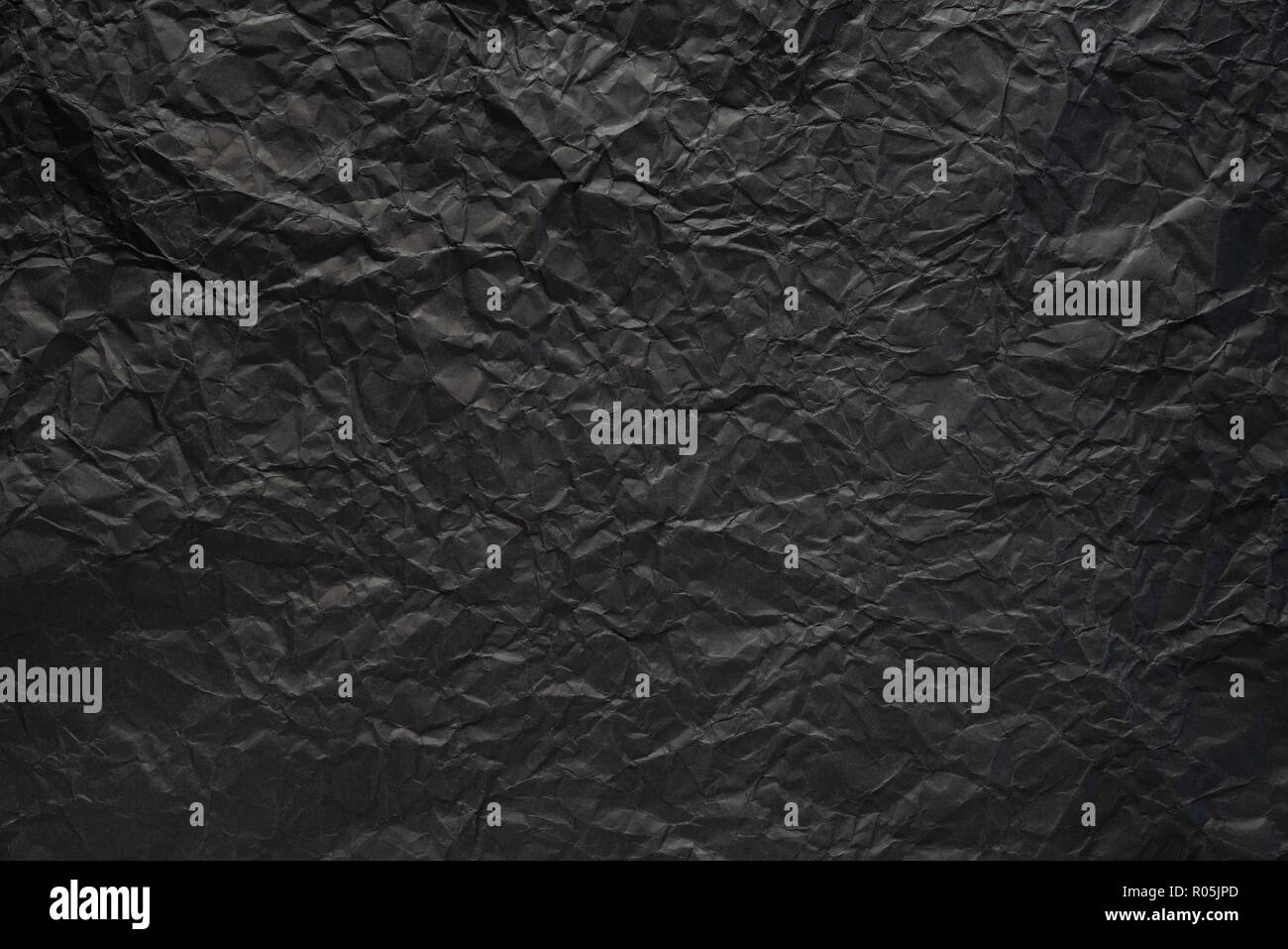 Black crumpled paper texture background Stock Photo - Alamy