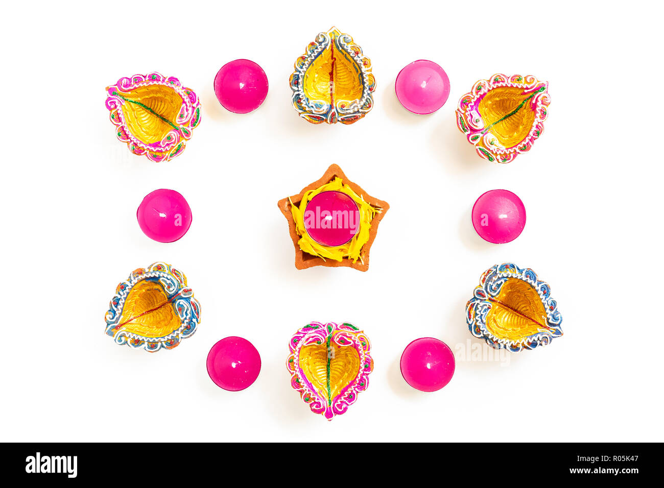Happy Diwali - Clay Diya lamps lit during Dipavali, Hindu festival of lights celebration. Colorful traditional oil lamp diya on white background Stock Photo