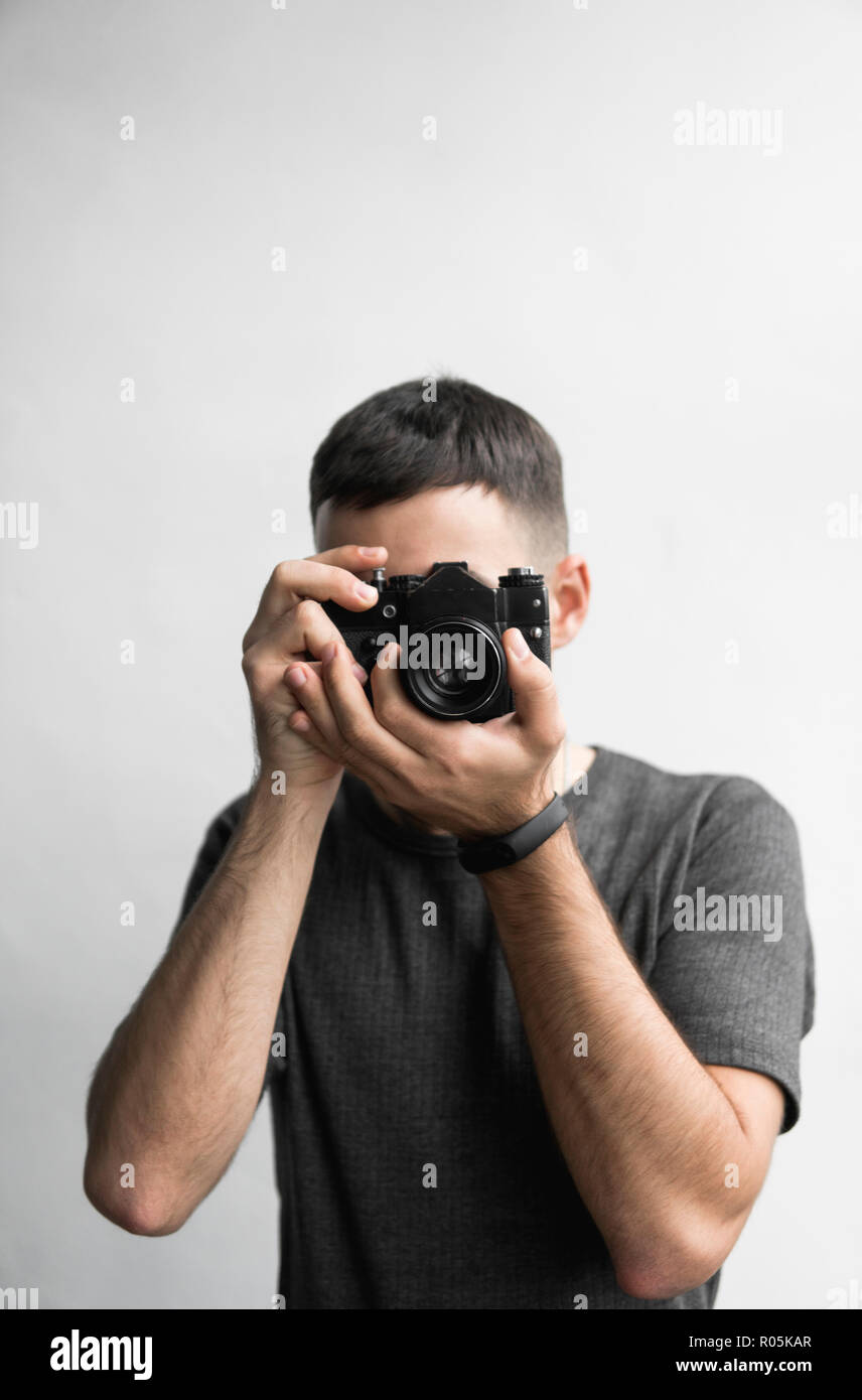 Handsome young bearded man in a black shirt holding vintage old ...