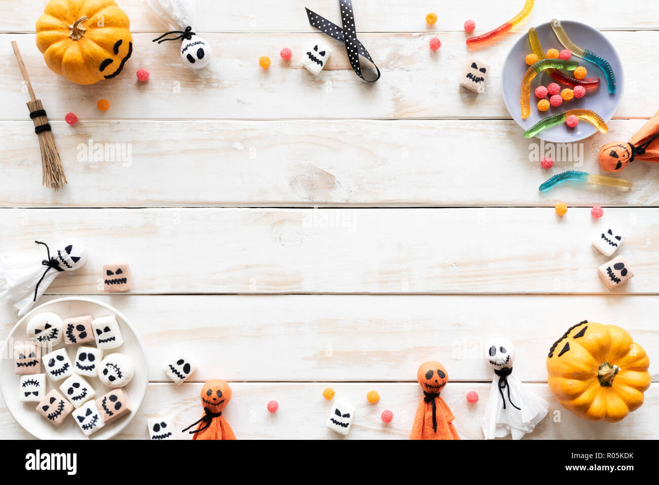 Top view of white and yellow ghost pumpkins with bat spider mummy jelly ...