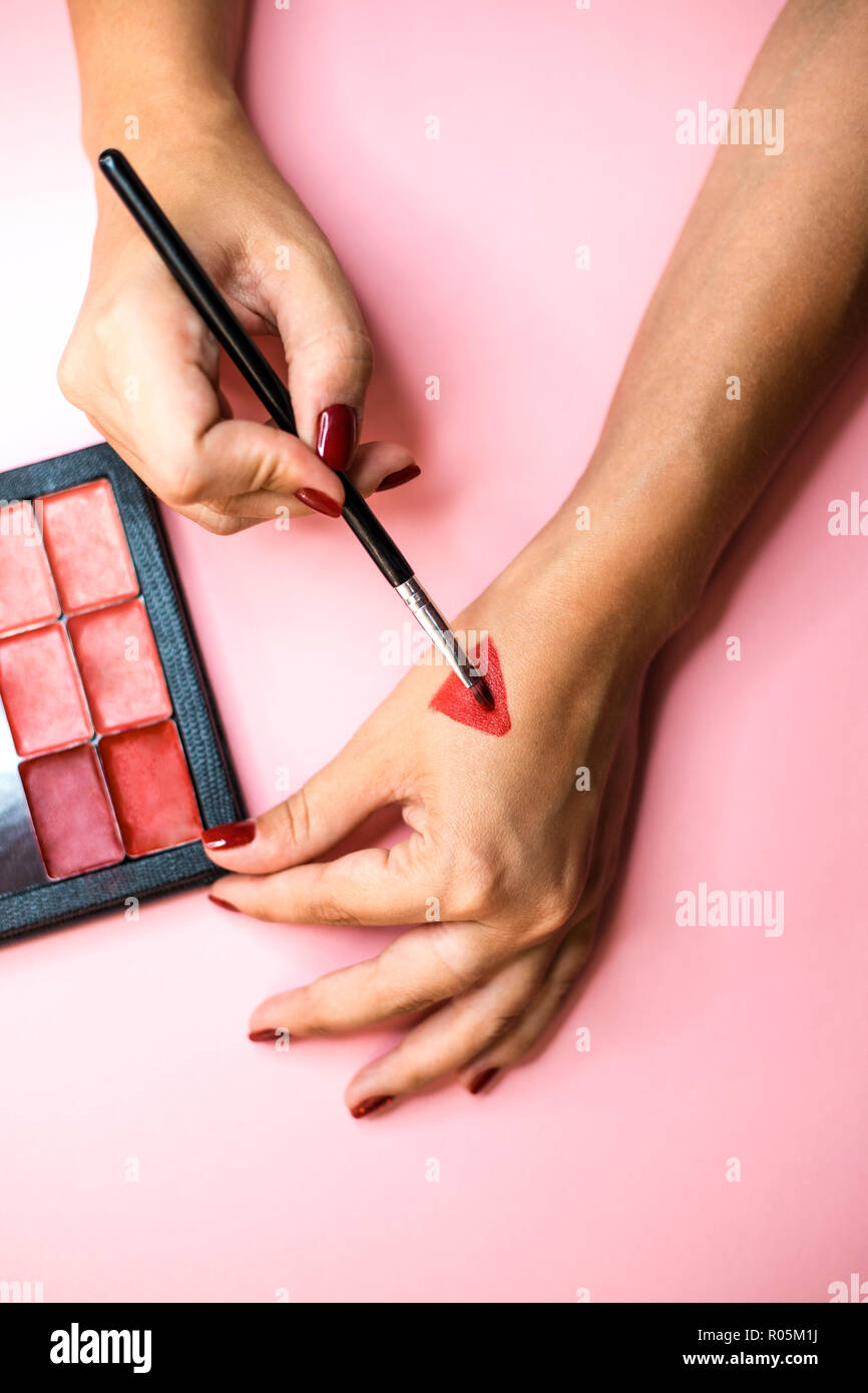 Red lipstick makeup swatches on female hand Stock Photo Alamy