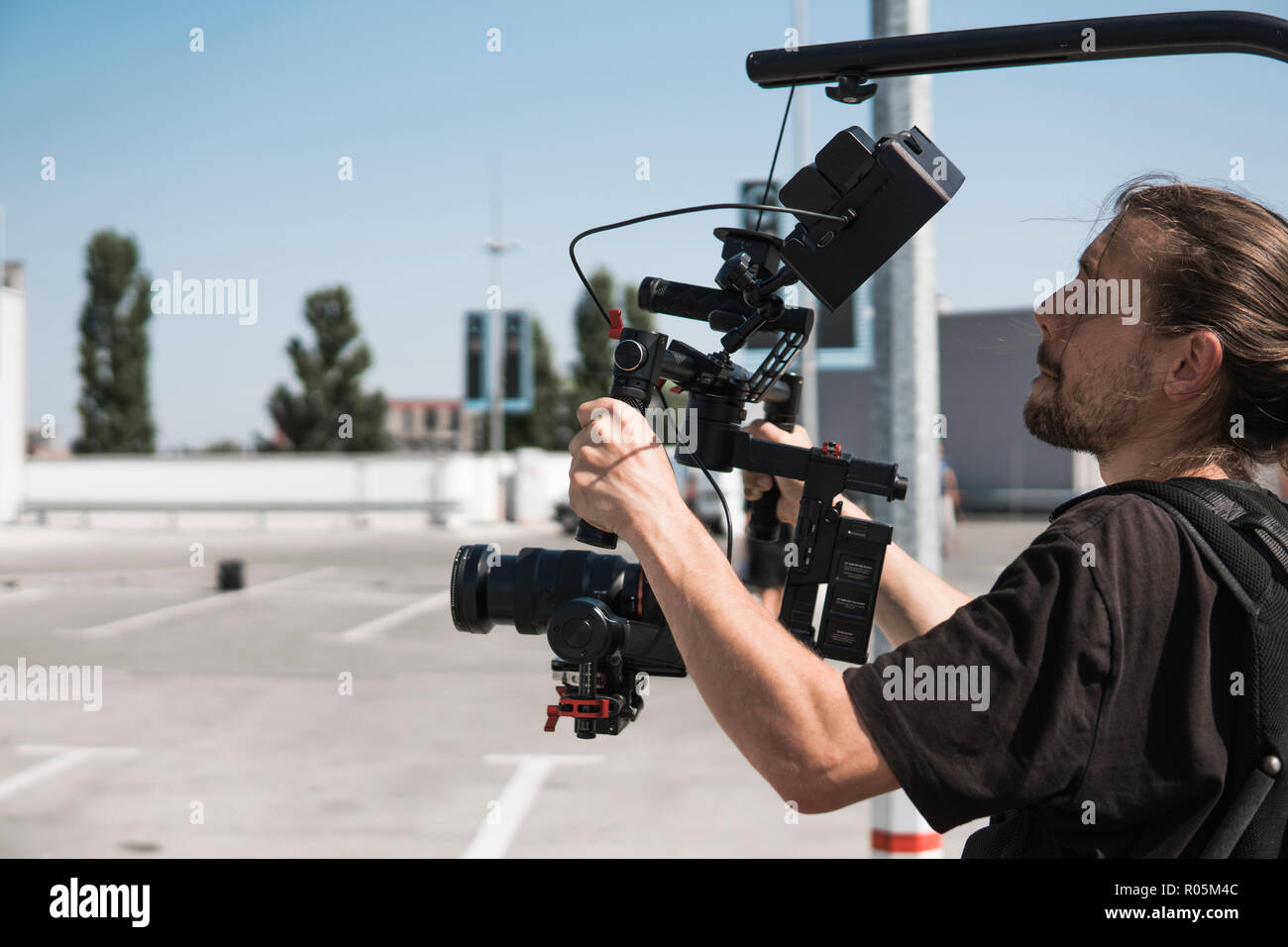 Videographer Rigs Professional videographer holding camera on 3-axis gimbal which mounted ...