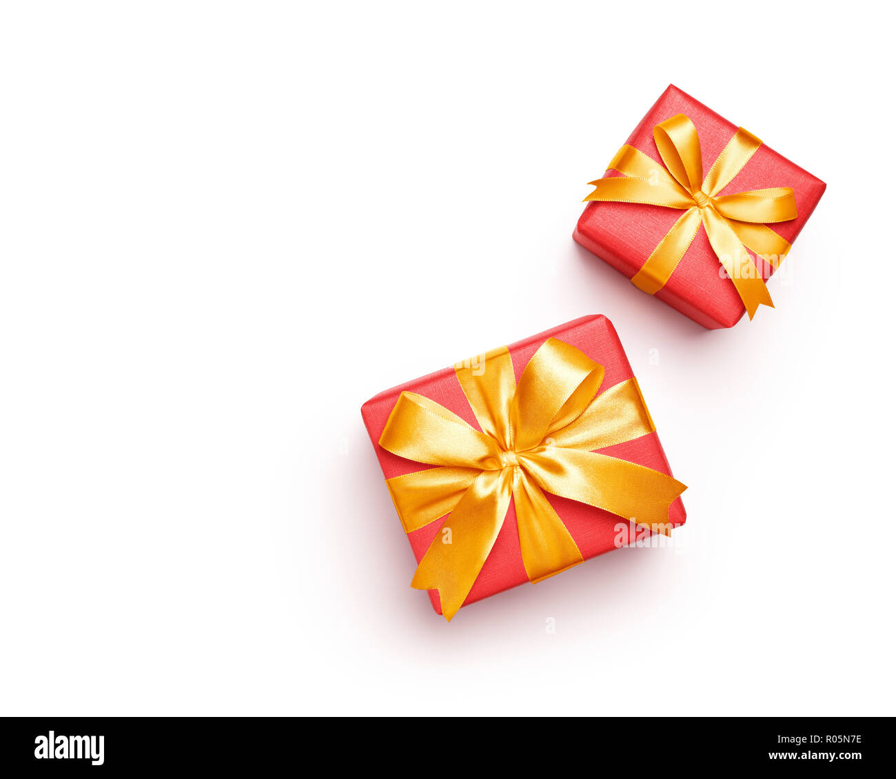 Red gift boxes with gold color bow over white background Stock Photo ...