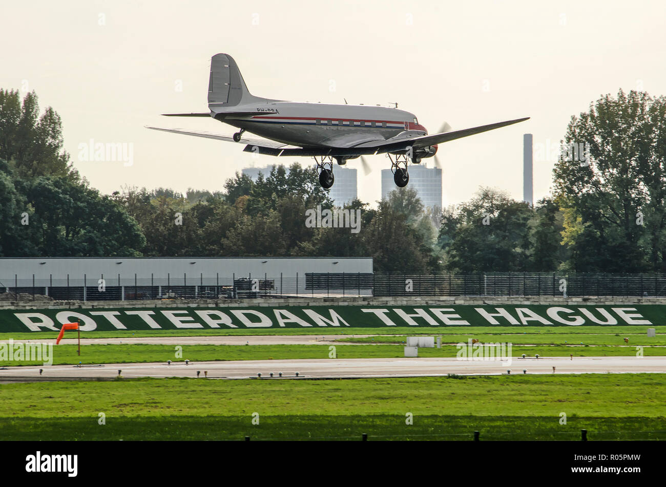 Rotterdam, The Netherlands, October 20, 2018: Small plane landing at Rotterdam The Hague airport, with a section of the city's skyline in the backgrou Stock Photo