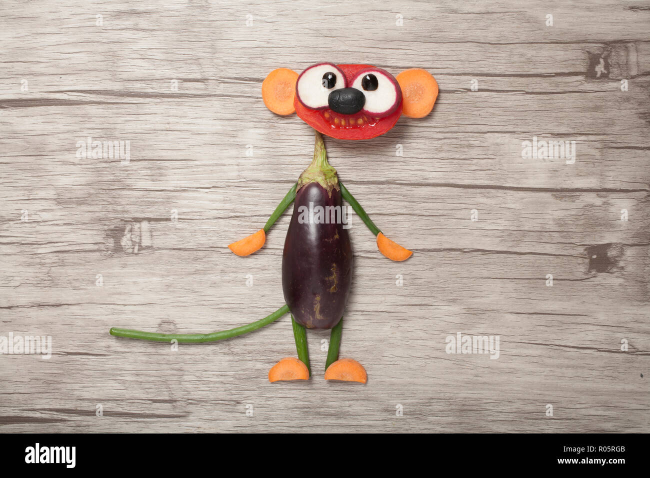 Funny vegetable suricate made on wooden background Stock Photo
