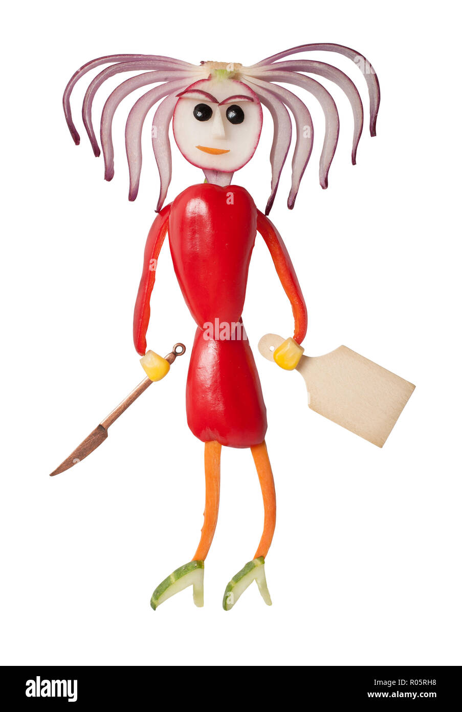 Girl made with vegetables holding knife and cutting board Stock Photo