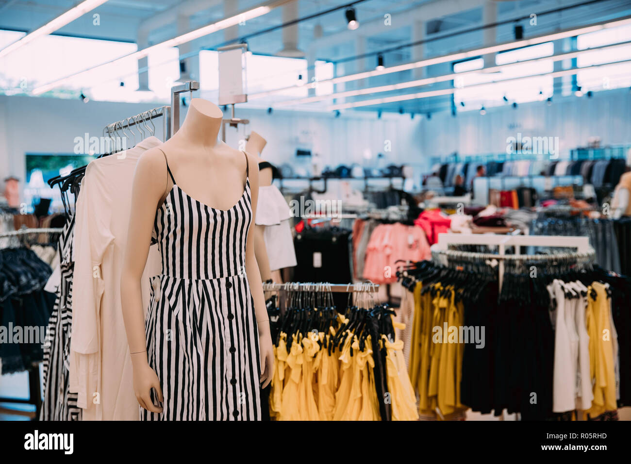 Mannequin Dressed In Female Casual Dress And Clothes On Shelves And Hanger  In Store Of Shopping Mall Stock Photo - Alamy