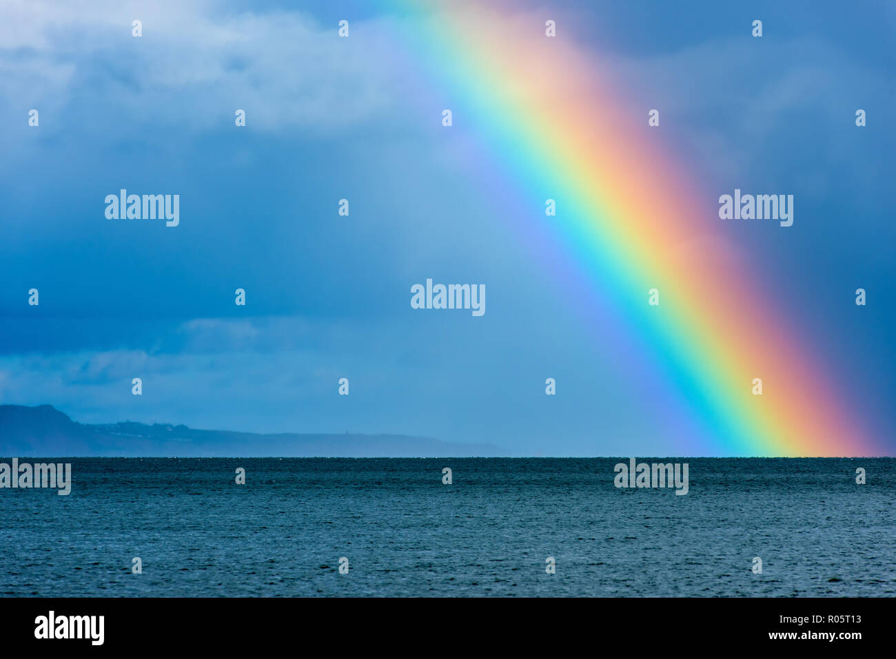 Rainbow and sea. Stock Photo