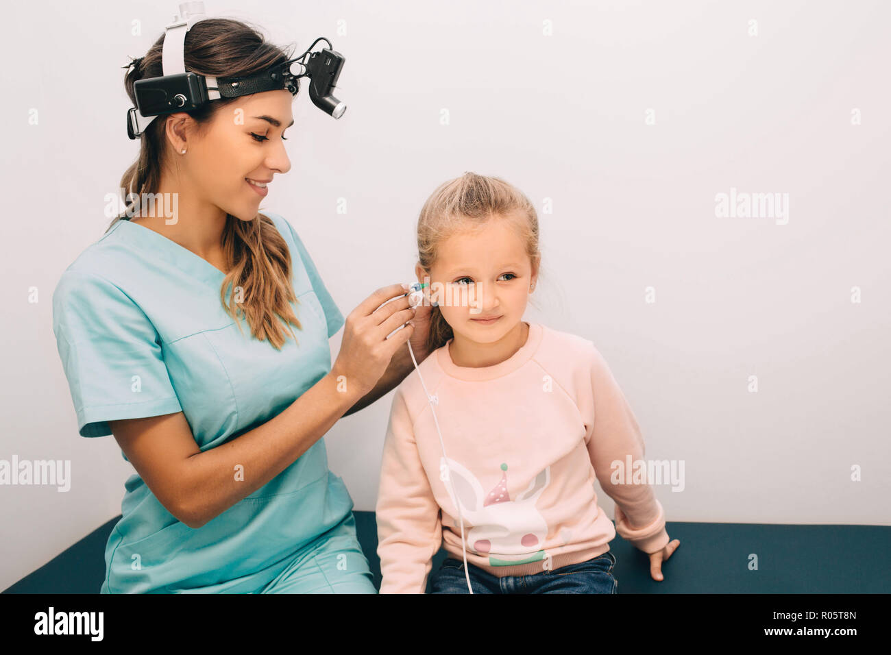 doctor check a girl's ears. Hearing exam at doctors office Stock Photo